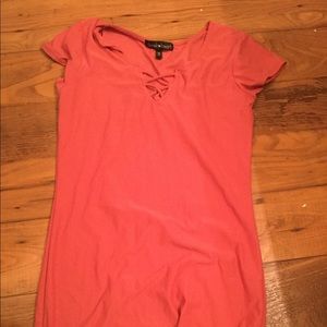 All pink t-shirt dress with lacing in the front.